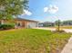 House exterior with a landscaped yard and driveway at 1810 Haverford Ave, Sun City Center, FL 33573
