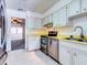 Cozy kitchen with stainless steel appliances and light wood cabinets at 1810 Haverford Ave, Sun City Center, FL 33573