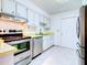 Kitchen with stainless steel appliances and light cabinets at 1810 Haverford Ave, Sun City Center, FL 33573