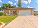 House exterior with a driveway and landscaping at 1810 Haverford Ave, Sun City Center, FL 33573