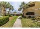 Walkway to pool area with tropical landscaping and condo buildings at 1228 S. Missouri Ave # 607, Clearwater, FL 33756