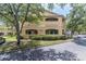 Two-story condo building with light yellow exterior and landscaping at 1228 S. Missouri Ave # 607, Clearwater, FL 33756