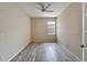 Well-lit bedroom with ceiling fan and wood-look tile flooring at 1013 Emerald Dunes Dr, Sun City Center, FL 33573