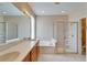 Bathroom boasts double sinks, a soaking tub, and a shower at 1013 Emerald Dunes Dr, Sun City Center, FL 33573