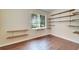 Home office featuring built-in shelving and wood flooring at 1013 Emerald Dunes Dr, Sun City Center, FL 33573