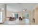 Open living room with high ceilings, ceiling fan and adjacent dining area at 1013 Emerald Dunes Dr, Sun City Center, FL 33573