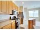 Kitchen with light wood cabinets, stainless steel appliances, and a kitchen island at 1013 Emerald Dunes Dr, Sun City Center, FL 33573
