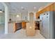 Kitchen with light wood cabinets, stainless steel appliances, and an island at 1013 Emerald Dunes Dr, Sun City Center, FL 33573