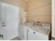 Bright laundry room with washer, dryer, and ample shelving at 1013 Emerald Dunes Dr, Sun City Center, FL 33573