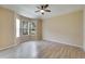 Bright bedroom with wood-look floors and a ceiling fan at 1013 Emerald Dunes Dr, Sun City Center, FL 33573