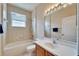 Clean bathroom with tub, shower, and updated vanity at 1013 Emerald Dunes Dr, Sun City Center, FL 33573
