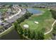 Aerial view of golf course community with lake at 1013 Emerald Dunes Dr, Sun City Center, FL 33573