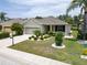 One-story house with a two-car garage and landscaped yard at 1013 Emerald Dunes Dr, Sun City Center, FL 33573