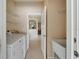 Laundry room with washer, dryer, utility sink, and access to other areas at 1013 Emerald Dunes Dr, Sun City Center, FL 33573