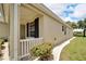 Side view of the house with white railing and landscaping at 1013 Emerald Dunes Dr, Sun City Center, FL 33573
