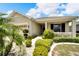 House exterior with a paved walkway and manicured landscaping at 1013 Emerald Dunes Dr, Sun City Center, FL 33573