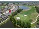 Aerial view of home on golf course community with lake at 1013 Emerald Dunes Dr, Sun City Center, FL 33573
