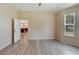Bedroom with wood-look floors and access to another room at 1013 Emerald Dunes Dr, Sun City Center, FL 33573