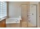 Bathroom features a soaking tub and a separate shower at 1013 Emerald Dunes Dr, Sun City Center, FL 33573