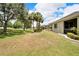 House with grassy backyard and mature trees at 1013 Emerald Dunes Dr, Sun City Center, FL 33573