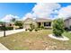 One-story house with a two-car garage and landscaped yard at 1013 Emerald Dunes Dr, Sun City Center, FL 33573