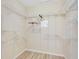 Large walk-in closet with wire shelving and hanging rods at 1013 Emerald Dunes Dr, Sun City Center, FL 33573