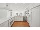 Bright white kitchen featuring an island, modern appliances, and ample counter space at 386 Club Manor Dr, Sun City Center, FL 33573
