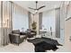 Bright home office features two comfortable armchairs, a desk, and large windows at 6018 Kipps Colony E Dr, Gulfport, FL 33707