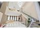 High-ceiling living room with modern staircase and chandelier at 6018 Kipps Colony E Dr, Gulfport, FL 33707