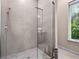 Modern shower with glass enclosure and hexagon tile floor at 6018 Kipps Colony E Dr, Gulfport, FL 33707