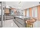 Spacious kitchen island with seating and a built-in wine cooler at 6018 Kipps Colony E Dr, Gulfport, FL 33707