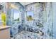 Spa-like shower with blue patterned tile and multiple shower heads at 6018 Kipps Colony E Dr, Gulfport, FL 33707