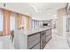 Open concept kitchen with island and breakfast bar overlooking living area at 6018 Kipps Colony E Dr, Gulfport, FL 33707