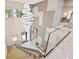 Elegant two-story entryway with a stunning chandelier and glass staircase at 6018 Kipps Colony E Dr, Gulfport, FL 33707