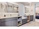 Elegant bathroom with dual vanities, a built-in bench, and natural light at 6018 Kipps Colony E Dr, Gulfport, FL 33707