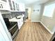 Modern kitchen with white cabinets, stainless steel appliances, and mosaic backsplash at 1703 Mobile Ave, Tampa, FL 33610