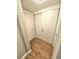 Hallway with light wood laminate flooring and built-in closet at 1703 Mobile Ave, Tampa, FL 33610