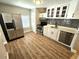 Modern kitchen with stainless steel appliances and white cabinets at 1703 Mobile Ave, Tampa, FL 33610