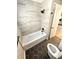 Renovated bathroom featuring a tub and shower, new tile, and updated fixtures at 1703 Mobile Ave, Tampa, FL 33610