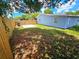 Large backyard with grassy area and wooden fence at 1703 Mobile Ave, Tampa, FL 33610