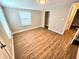 Well-lit bedroom with wood-look flooring and closet at 1703 Mobile Ave, Tampa, FL 33610