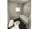 Updated bathroom with a tub, hexagon tile floor and modern fixtures at 1703 Mobile Ave, Tampa, FL 33610