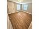 Bedroom with wood-look flooring and exterior door access at 1703 Mobile Ave, Tampa, FL 33610