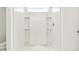 White shower with built-in shelving at 10623 Hidden Banks Gln, Parrish, FL 34219