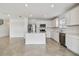 Modern kitchen with white cabinets, stainless steel appliances, and an island at 10619 Hidden Banks Gln, Parrish, FL 34219