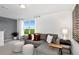 Cozy living room with grey sectional sofa and large window at 10619 Hidden Banks Gln, Parrish, FL 34219