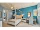 Bedroom with a white canopy bed, blue walls, and ample natural light at 12310 Stonelake Ranch Blvd, Thonotosassa, FL 33592