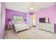 Lavender bedroom with a comfortable bed and built-in media console at 12310 Stonelake Ranch Blvd, Thonotosassa, FL 33592