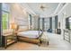 Spacious main bedroom with a large four-poster bed, sitting area, and ample natural light at 12310 Stonelake Ranch Blvd, Thonotosassa, FL 33592