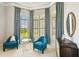 Relaxing sitting area with two comfy armchairs and plenty of natural light at 12310 Stonelake Ranch Blvd, Thonotosassa, FL 33592